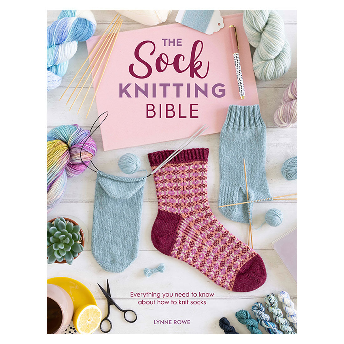 Book titled 'The Sock Knitting Bible' with sock knitting materials on a wooden surface.