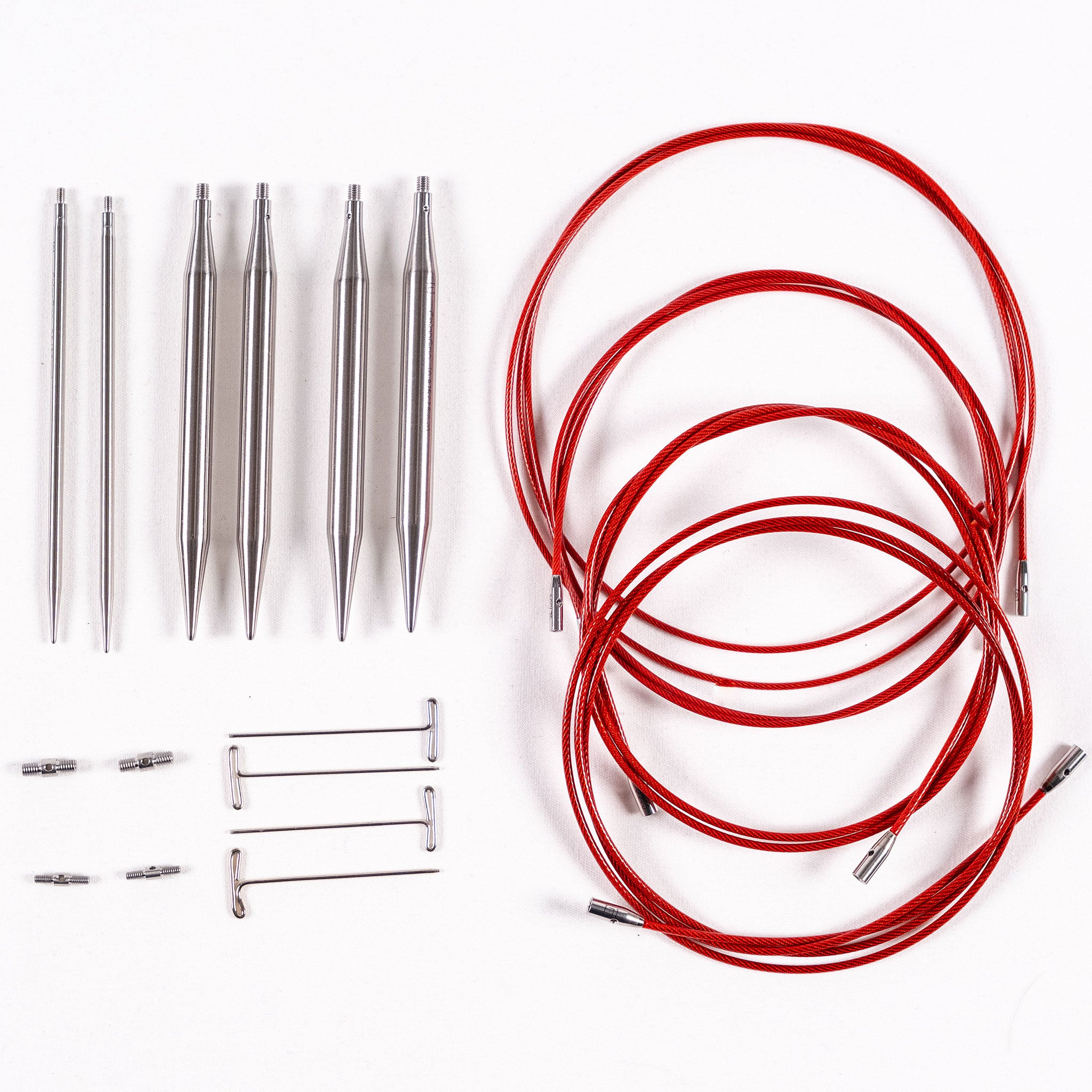 Three pairs of ChiaoGoo 4in long stainless steel interchangeable knitting needle tips, four tightening keys, two small and two large cable connectors, and four red lace interchangeable cables with lifeline holes