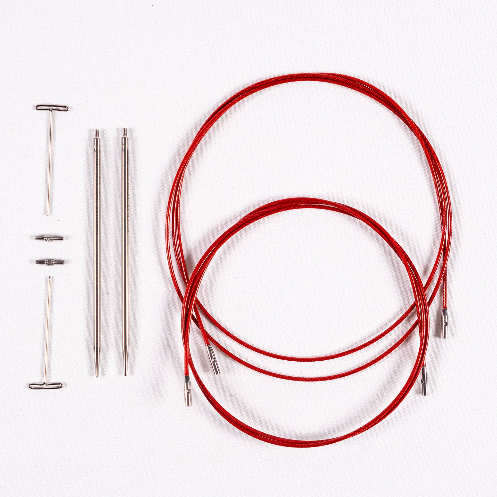 One pair of 3mm ChiaoGoo 4in long stainless steel interchangeable tips, two tightening keys, two small stainless steel cable connectors, one 30in long and one 37in long TWIST Red Lace cable each coiled into a circle