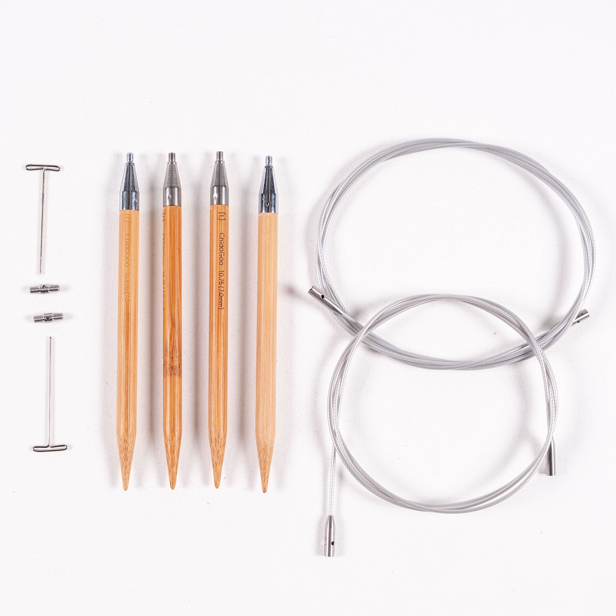Two pairs of ChiaoGoo SPIN 5in long bamboo tips in sizes 7mm and 7.5mm, two tightening keys, two large cable connectors and two SWIV360 silver cables on a white background