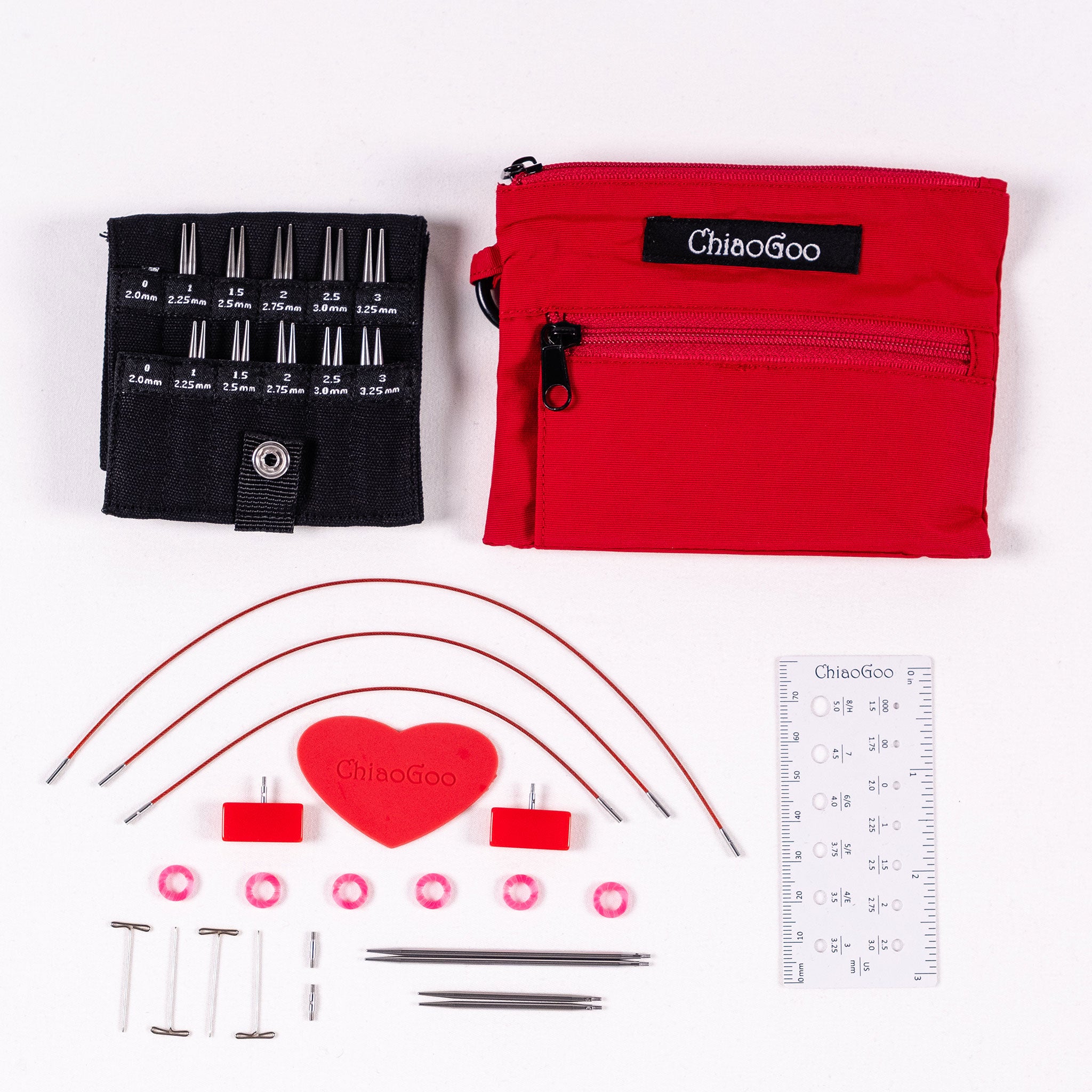ChiaoGoo Red Shorties set showing black labelled tip pocket with 2in and 3in tips, red nylon zippered pouch , 5in 6in 8in mini cables, red heart, mini end stoppers, six pink stitch markers, four tightening keys, two mini cable connectors, 5in long ruler needle gauge