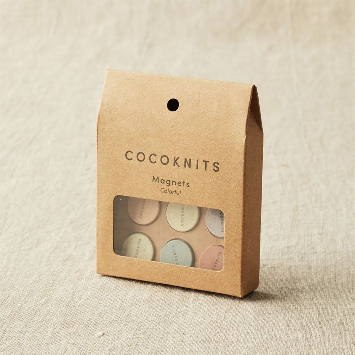Cocoknits magnets packaging on a beige fabric background