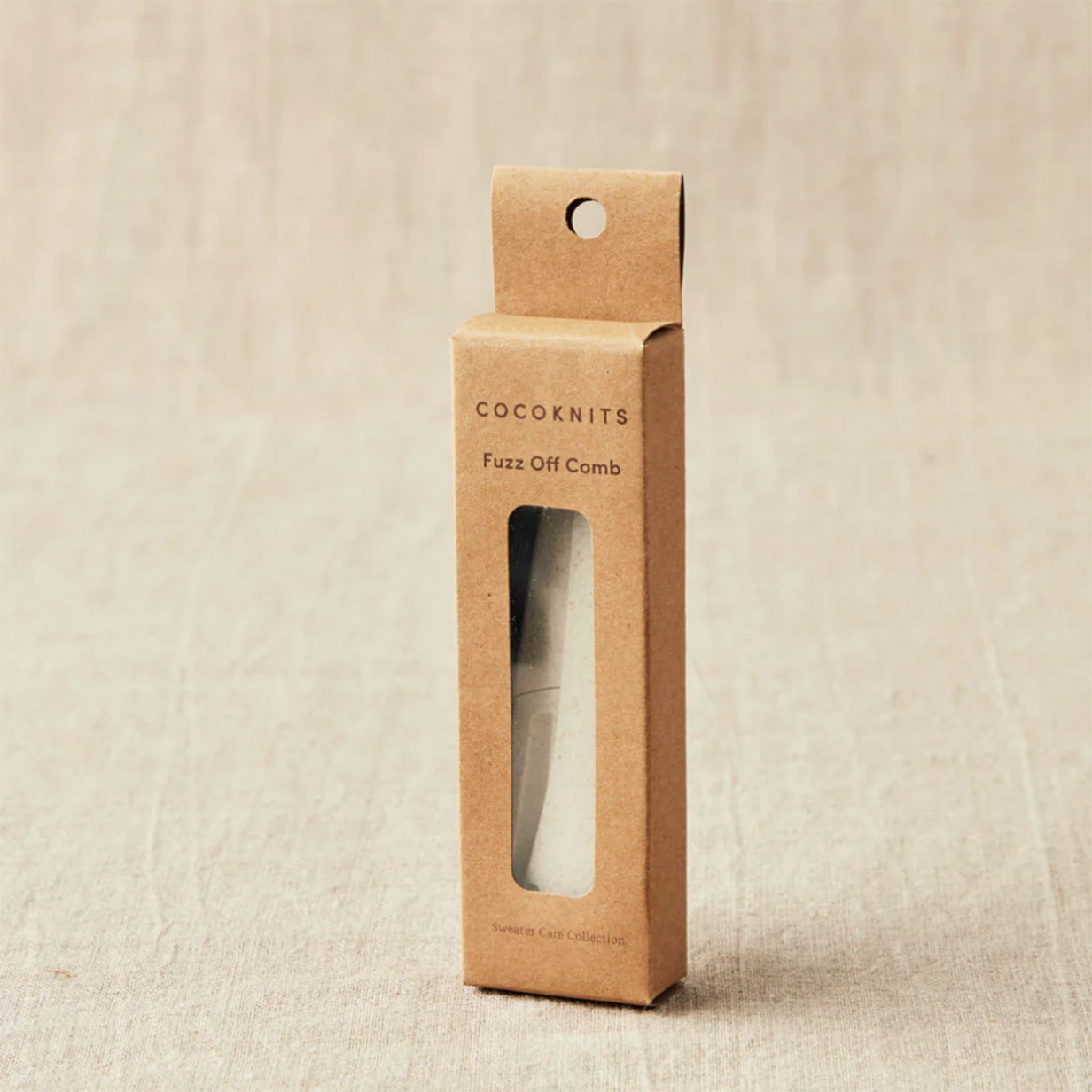 Cocoknits Fuzz Off Comb packaging on a linen background