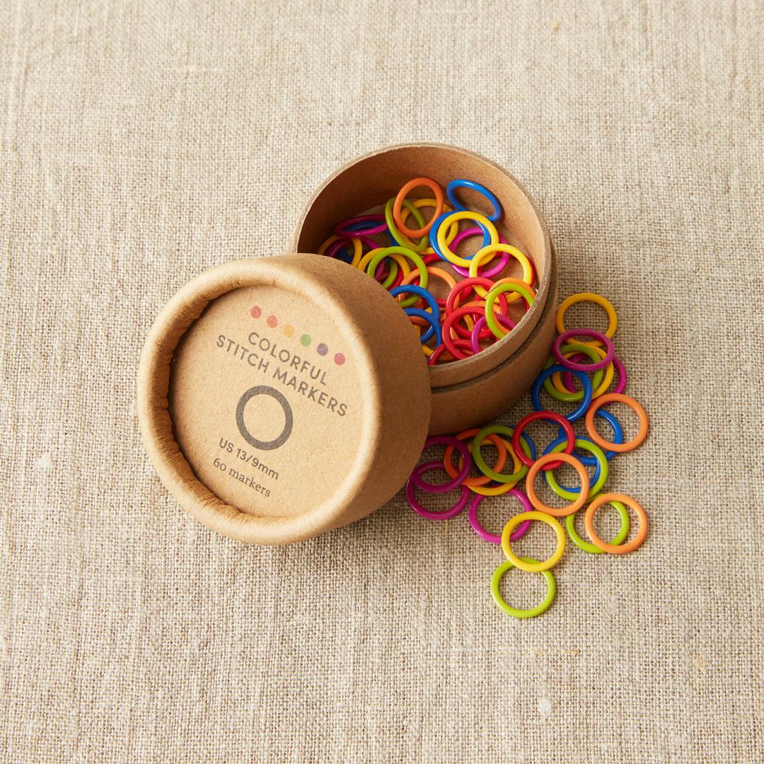 A tub of 60 fixed ring stitch markers in blue, orange, yellow, pink, green and red