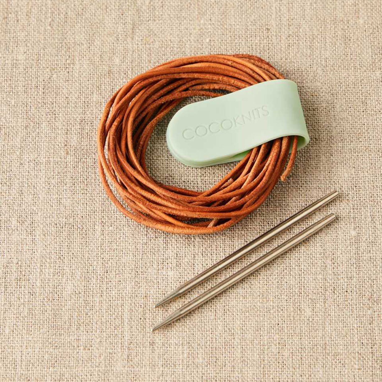 Mint green Cocoknits magnetic clip holding leather cord