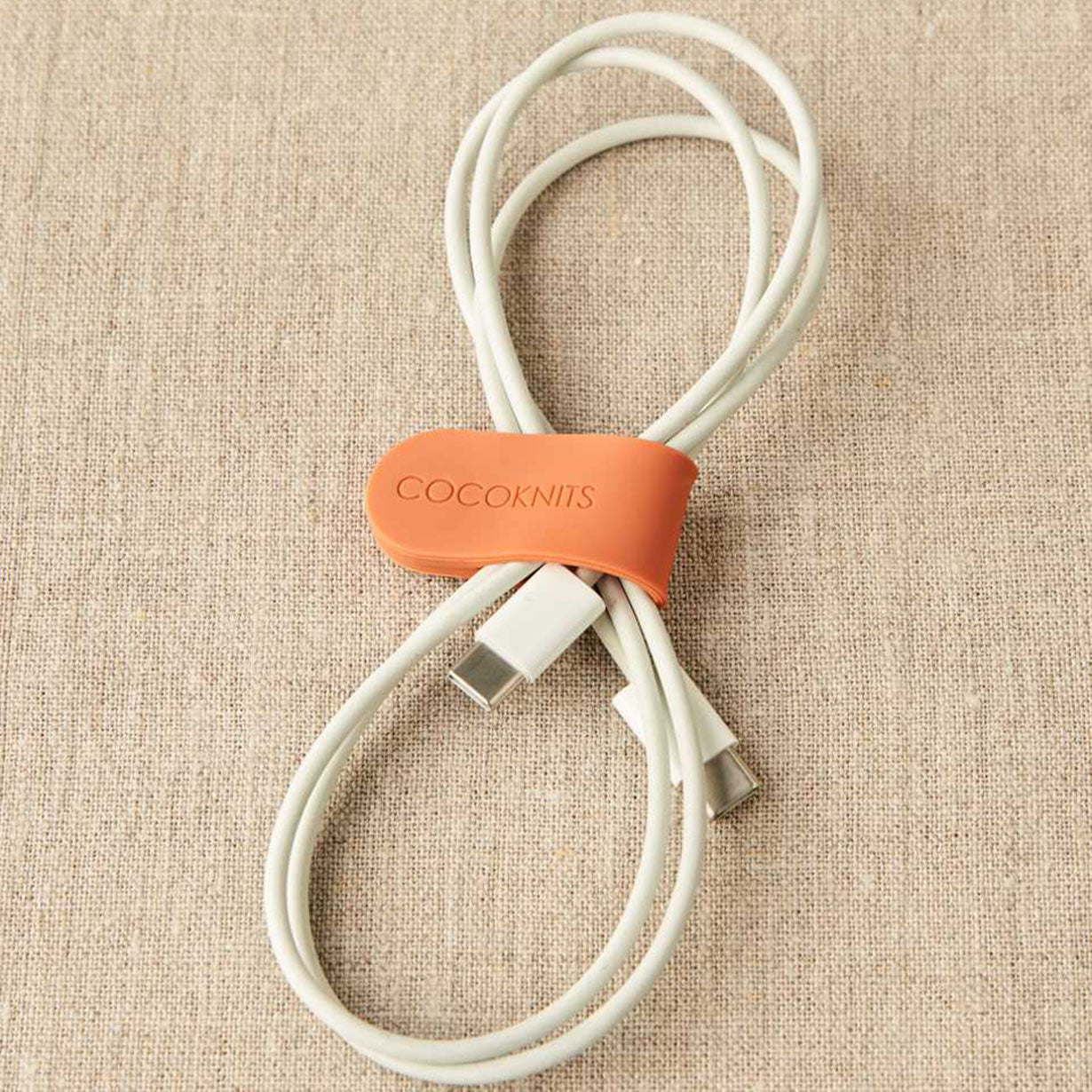 Cocoknits orange makers clip holding C type charging cable in figure of eight
