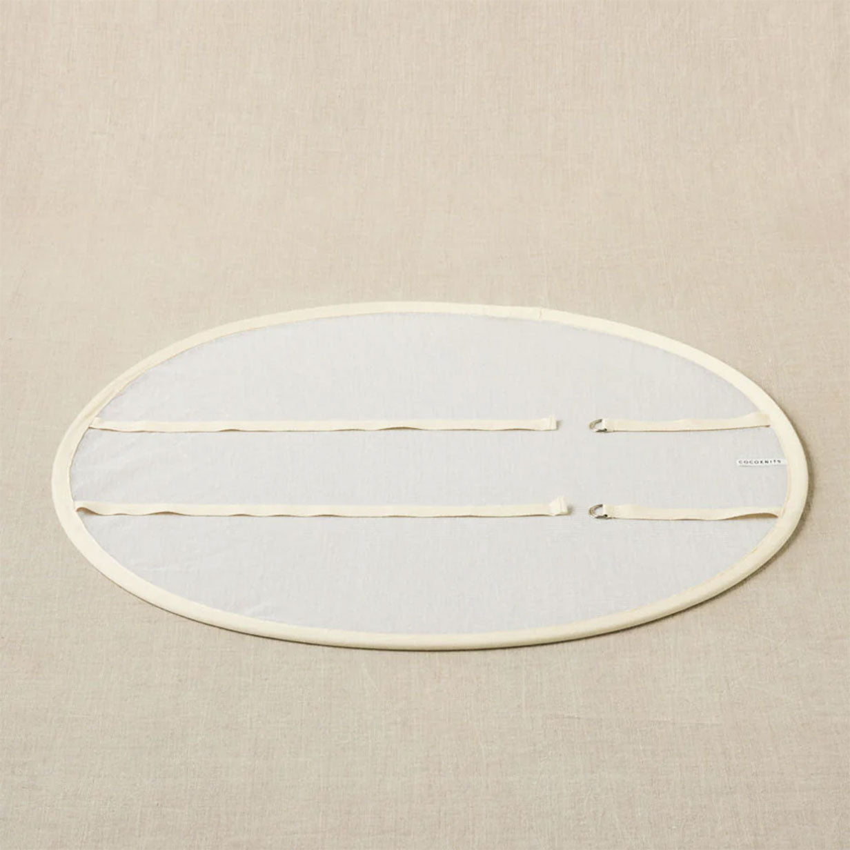 Pop up sweater dryer with COCOKNITS logo label lying flat with straps unconnected