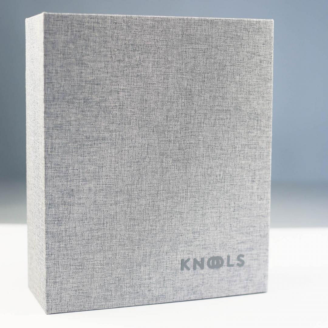 Grey needle garage folder with KNOOLS logo standing closed on a white surface