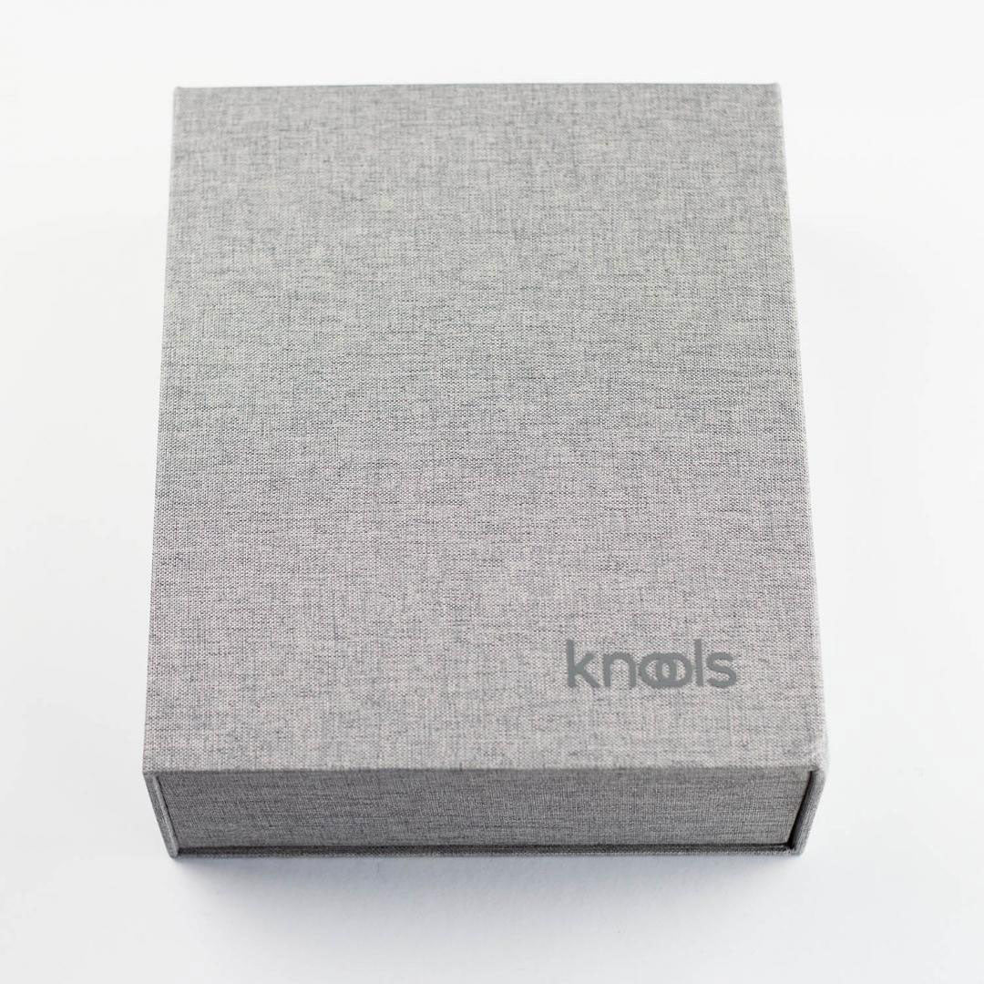 Closed grey fabric covered ring binder with KNOOLS logo