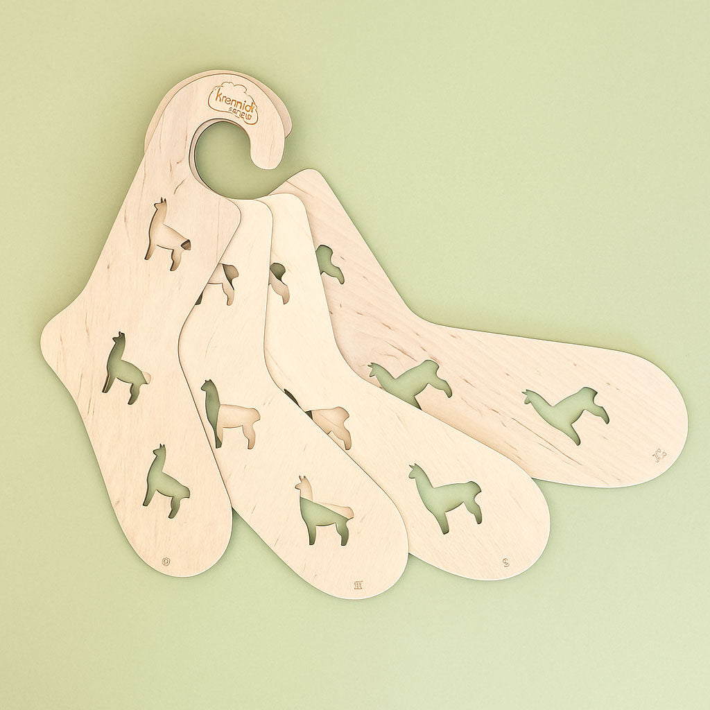 Kremke socks blockers in S, M, L and XL shown in a fan shape on a sage green background