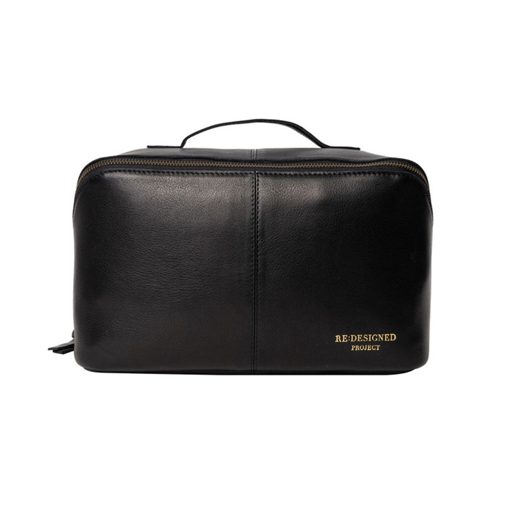 Black leather knitting project bag with 'RE:DESIGNED PROJECT' branding, on a white background