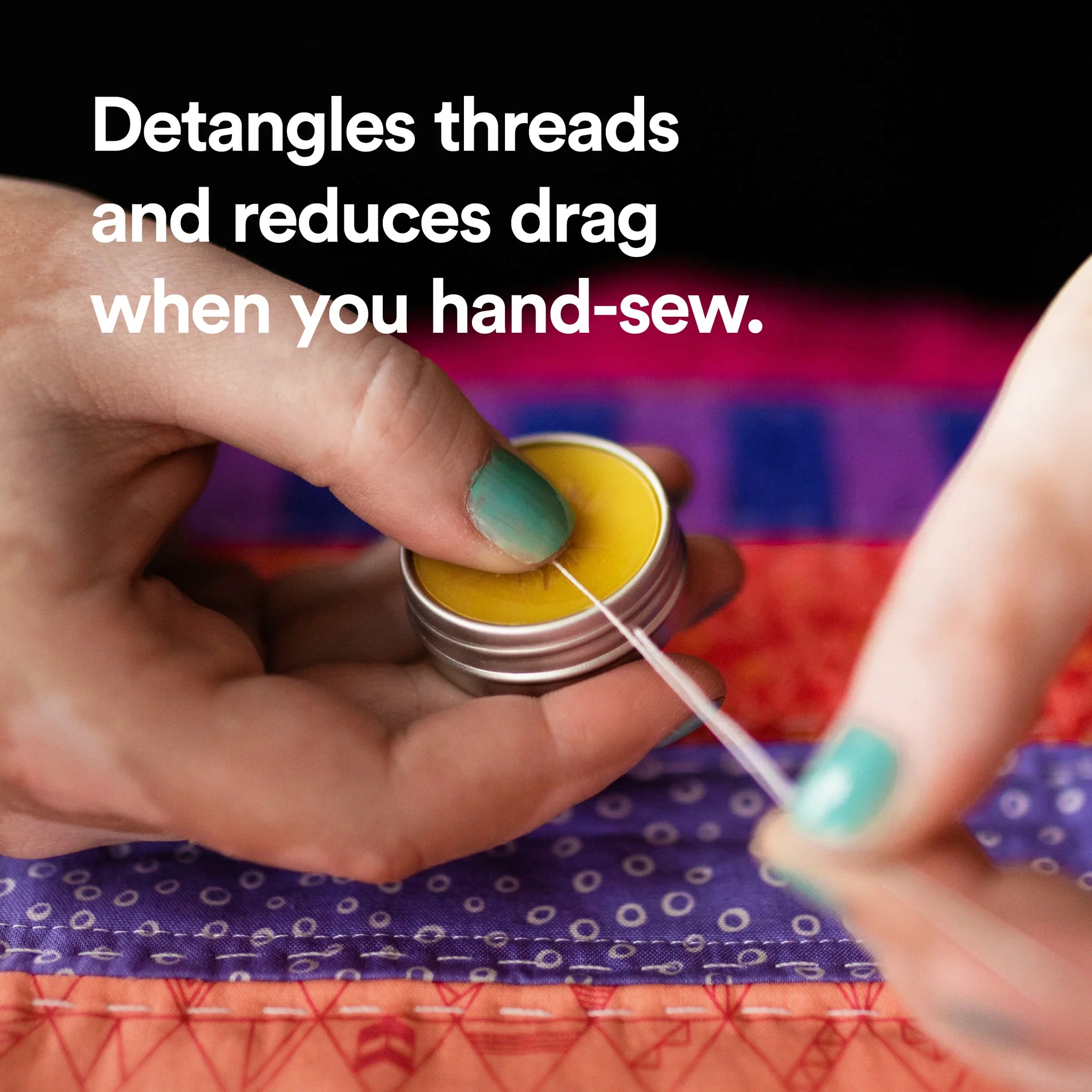 Hands dragging emboidery thread across an open tin of thread gloss