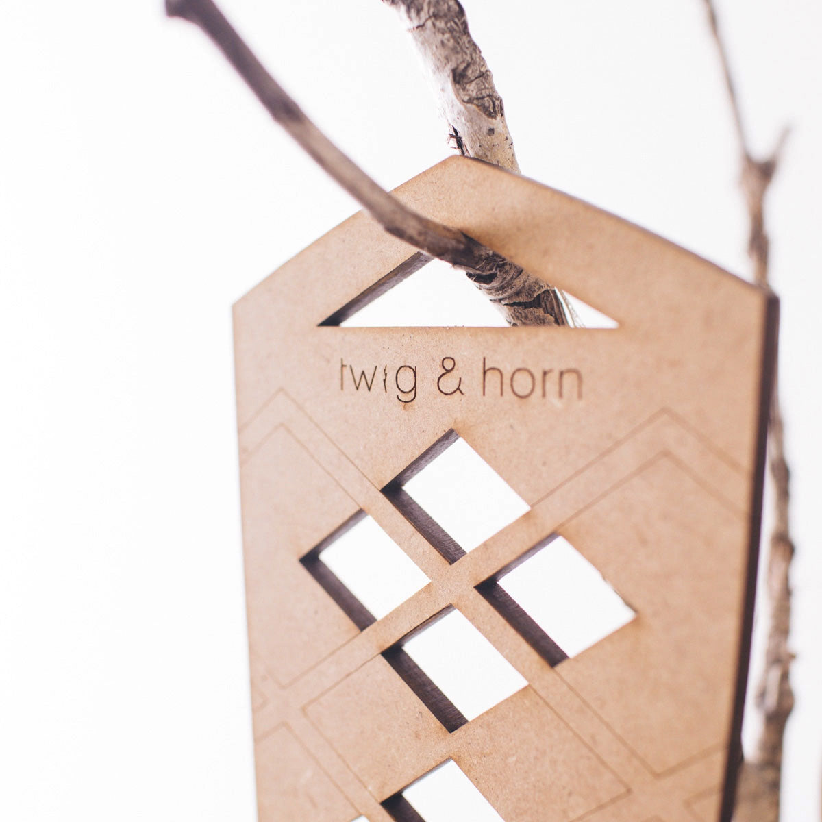 Close up of Twig & Horn logo on top of MDF argle cut out section of sock blocker