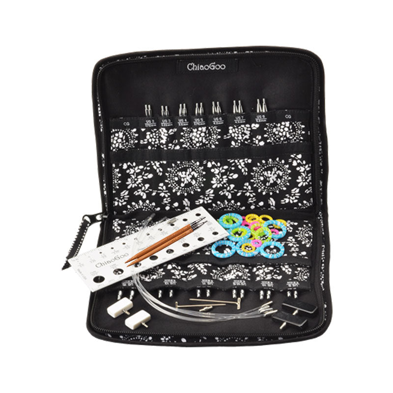 ChiaoGoo 4in bamboo interchangeable knitting needle set with various tools in a black case on a white background
