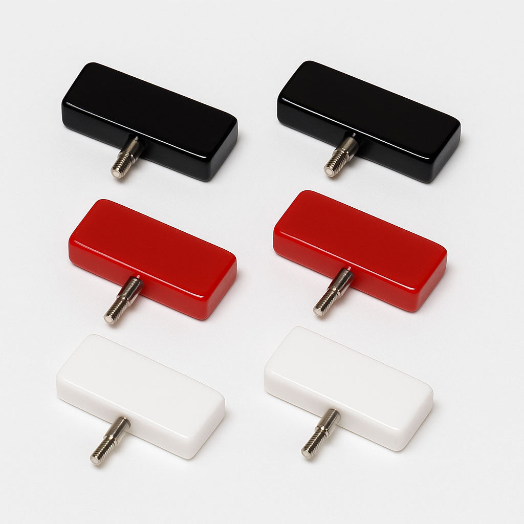 Three pairs of ChiaoGoo cable end stoppers, resin rectangles with male screw threads, black (large), red (mini) and white (small)