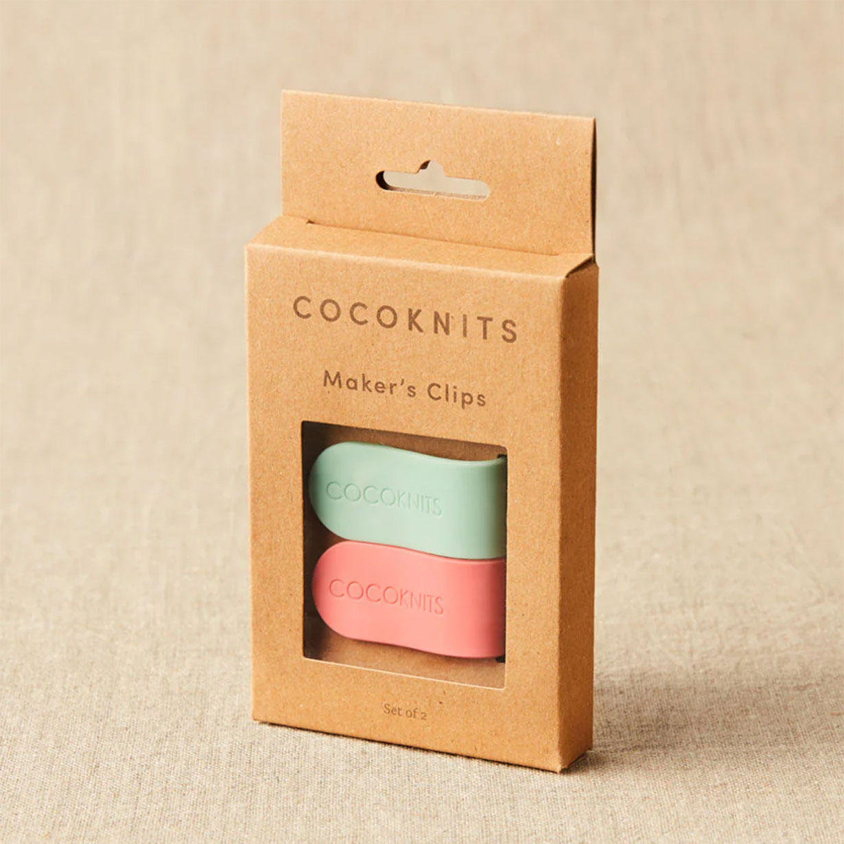 Cocoknits mint green and coral pink magnetic maker's clips in kraft cardboard packaging