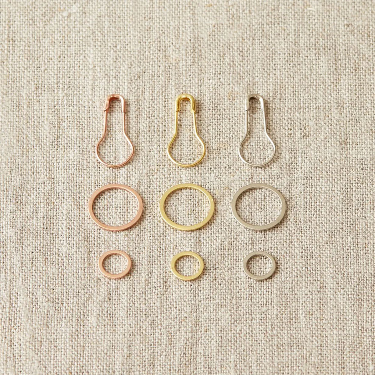 Three matching sets of Cocoknits metal stitch markers, opening, large and small fixed ring, copper, gold and silver coloured