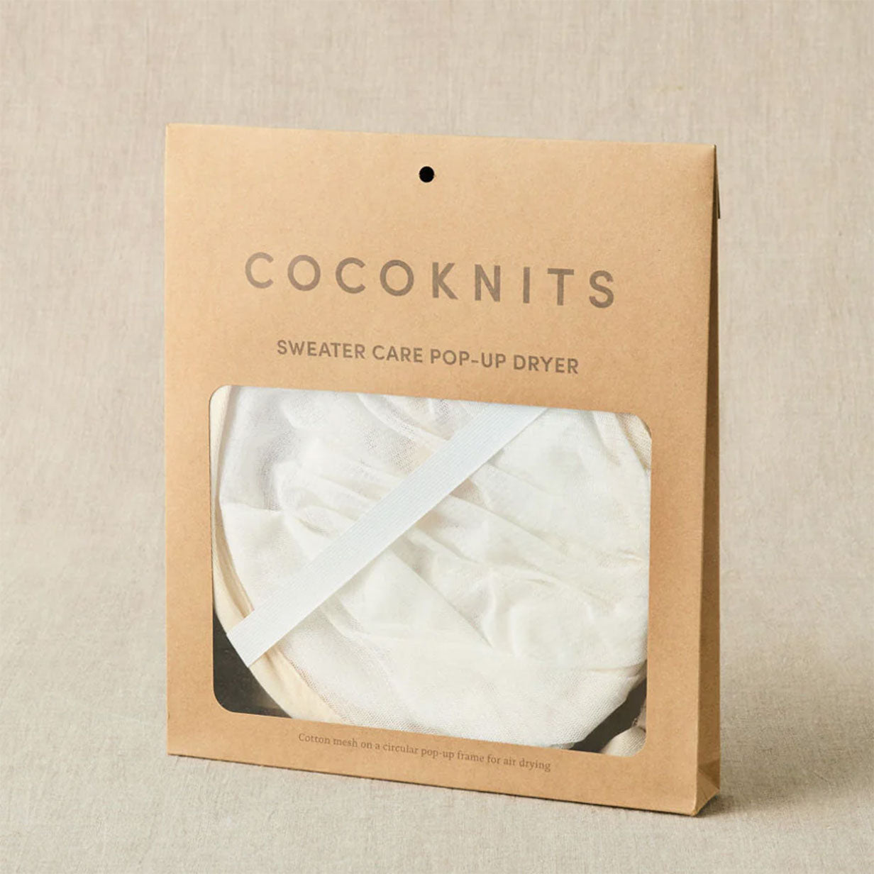 Cocoknits sweater care pop-up dryer packaging on a beige background