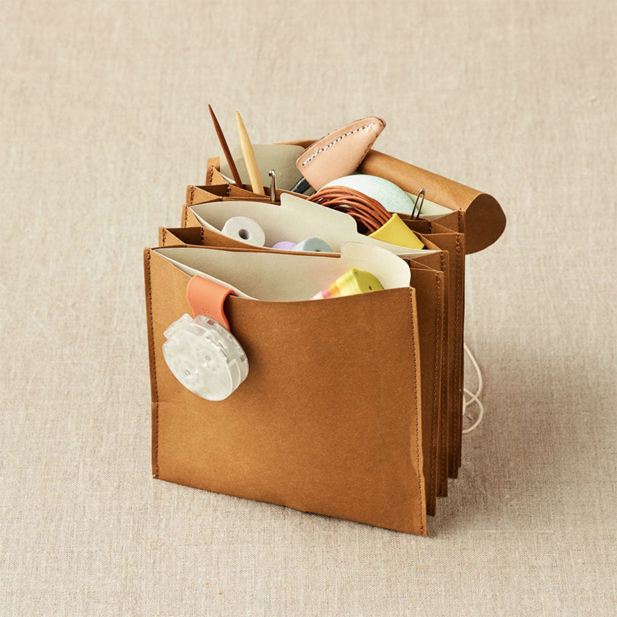 Cocoknits kraft coloured paper based miniature expanding file standing on linen background