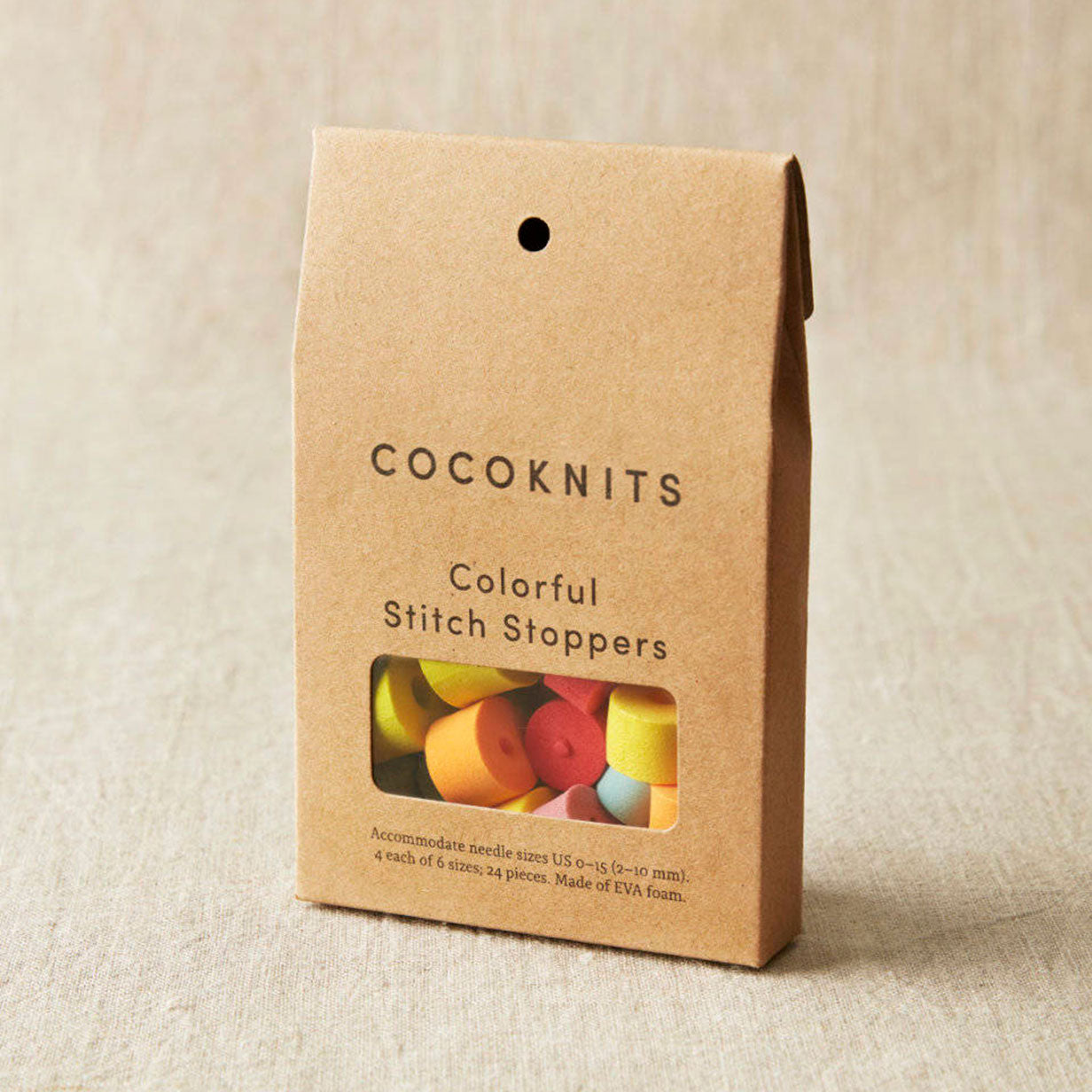 Cocoknits colorful stitch stoppers packaging on a beige background
