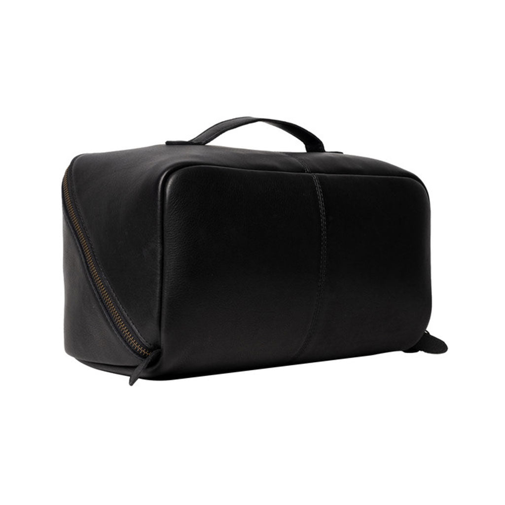 Black leather knitting project bag with a brass zip, on a white background