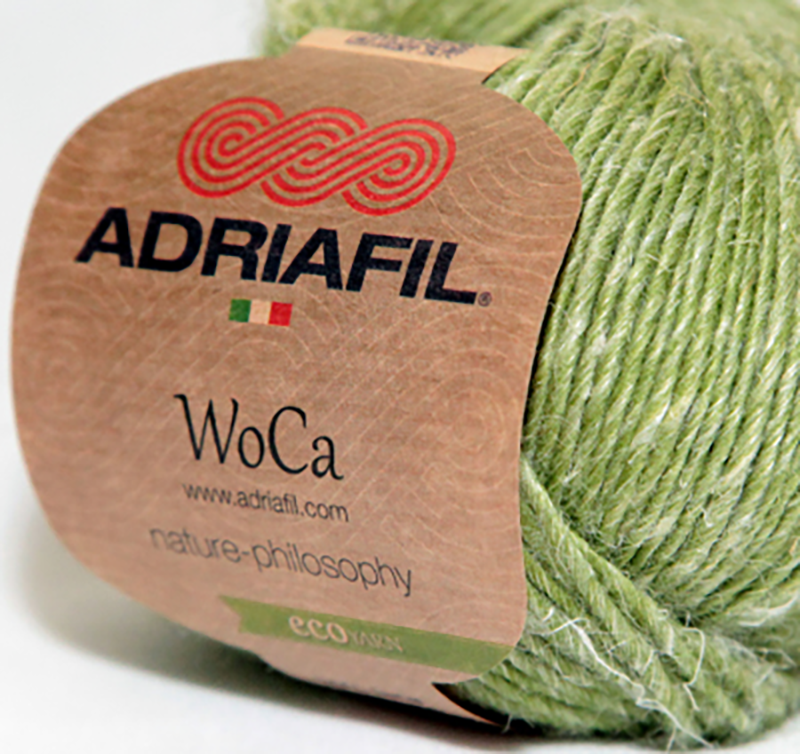 Close up of WoCa by Adriafil label on green coloured ball of yarn